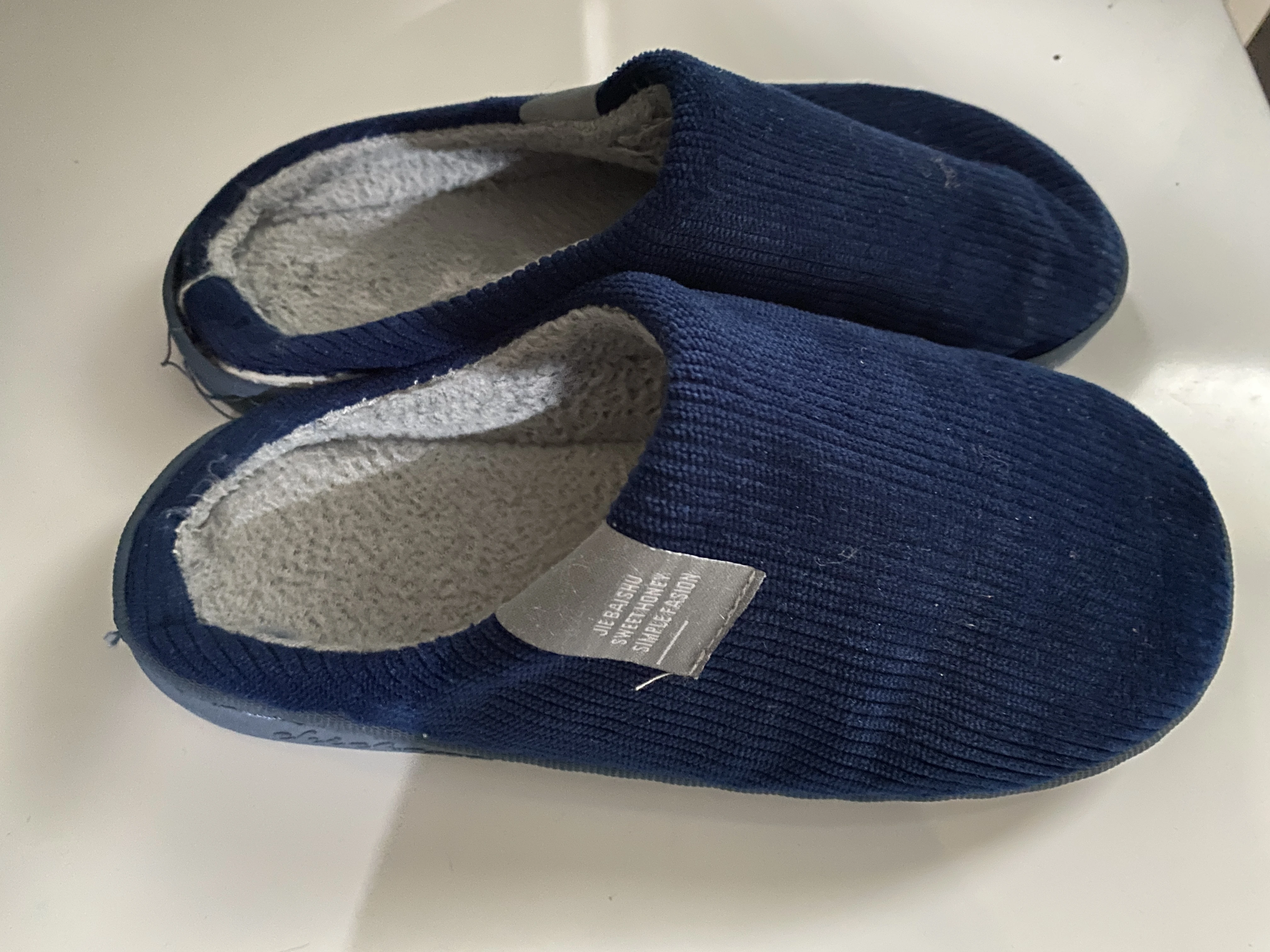 Instantly created AI lifestyle photo of a man with the slippers on display